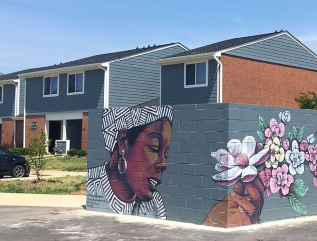 photo of maya angelou mural in front of homes